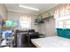 Practical laundry room with modern washer and dryer, storage shelves, and a functional folding table at 4229 Motocross Trl, Edgemoor, SC 29712