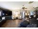 Cozy living room with hardwood floors, a dark leather sofa, patterned chairs, and a mounted TV at 4229 Motocross Trl, Edgemoor, SC 29712