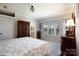 Tranquil main bedroom featuring a king bed, serene views from large windows, and stylish window treatment at 4229 Motocross Trl, Edgemoor, SC 29712
