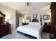 Spacious primary bedroom with traditional furnishings, lamps, and wall art above each nightstand at 4229 Motocross Trl, Edgemoor, SC 29712
