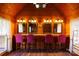 Salon space with four chairs and mirrors, wood paneling, and a chandelier at 4229 Motocross Trl, Edgemoor, SC 29712