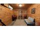 Cozy sitting area with wood paneling, cushioned chairs, and decorative rug at 4229 Motocross Trl, Edgemoor, SC 29712