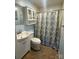 Bathroom featuring a toilet, sink and vanity, mirror, and shower with patterned curtain at 514 W Blume St, Landis, NC 28088