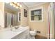 Neutral bathroom featuring a shower-tub combo with striped curtain, and a window for natural light at 5215 Milford Rd, Charlotte, NC 28210