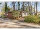 Well-maintained one-story home featuring a brick side and a spacious driveway with mature landscaping at 5215 Milford Rd, Charlotte, NC 28210