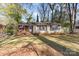 Charming single-story home with a brick facade, a manicured lawn, and mature trees at 5215 Milford Rd, Charlotte, NC 28210