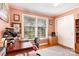 Bright home office featuring a large window, hardwood floors, and a functional workspace at 5215 Milford Rd, Charlotte, NC 28210