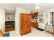 Bright kitchen space with wooden cabinets, adjacent to a cozy living room and dining area at 5215 Milford Rd, Charlotte, NC 28210