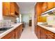 Functional kitchen featuring wooden cabinets, white countertops, and vintage details at 5215 Milford Rd, Charlotte, NC 28210