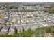 An aerial view highlighting a residential neighborhood featuring well-maintained homes, tree-lined streets, and a tranquil pond at 5827 Eleanor Rigby Rd, Charlotte, NC 28278