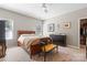 Cozy bedroom featuring a wood-framed bed, ceiling fan, and a walk-in closet for ample storage at 5827 Eleanor Rigby Rd, Charlotte, NC 28278