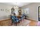 Classic dining room with hardwood floors, a large window and elegant furnishings including a round wooden table at 5827 Eleanor Rigby Rd, Charlotte, NC 28278