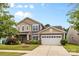 Charming two-story home with a well-manicured lawn, attached two-car garage, and beautiful curb appeal at 5827 Eleanor Rigby Rd, Charlotte, NC 28278