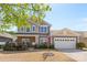 Charming two-story home with a brick facade, well-manicured landscaping, and an attached two-car garage at 5827 Eleanor Rigby Rd, Charlotte, NC 28278