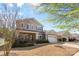 Well-maintained two-story home featuring a brick facade, lush landscaping, and a two-car attached garage at 5827 Eleanor Rigby Rd, Charlotte, NC 28278
