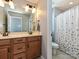 A stylish bathroom with a double sink vanity, mirrors, and separate toilet and shower area at 7240 Baybrooke Ln, Harrisburg, NC 28075