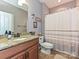 Neat bathroom featuring a granite countertop, framed mirror and shower with white curtain at 7240 Baybrooke Ln, Harrisburg, NC 28075