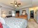 Large bedroom showcasing a wood dresser, ceiling fan, closet, and a plush patterned comforter at 7240 Baybrooke Ln, Harrisburg, NC 28075