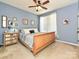 Comfortable bedroom featuring a wooden bed frame, a ceiling fan, and bright natural lighting at 7240 Baybrooke Ln, Harrisburg, NC 28075