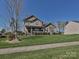 Charming two-story home boasts a well-manicured lawn, a porch, and classic curb appeal at 7240 Baybrooke Ln, Harrisburg, NC 28075