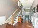 Elegant foyer with hardwood floors, staircase, and wainscoting, creating a grand entrance to the home at 7240 Baybrooke Ln, Harrisburg, NC 28075