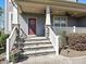 Charming front porch with stone steps, decorative pillars, and a welcoming front door with transom window at 7240 Baybrooke Ln, Harrisburg, NC 28075