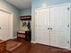 Hallway with built in storage, coat rack, and multiple entrances at 7240 Baybrooke Ln, Harrisburg, NC 28075