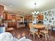 Open kitchen with stainless steel appliances, granite countertops, island with bar seating, and tile backsplash at 7240 Baybrooke Ln, Harrisburg, NC 28075
