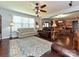 Inviting living room with sofas, ceiling fan, and an open floor plan to the kitchen and dining area at 7240 Baybrooke Ln, Harrisburg, NC 28075