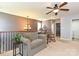 Bright loft featuring comfortable seating, a ceiling fan, and a view of the hallway at 7240 Baybrooke Ln, Harrisburg, NC 28075
