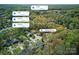 An aerial view showcases the home's proximity to Uptown, South End, and SouthPark with a tree-lined neighborhood at 7656 Eastbourne Rd, Charlotte, NC 28227