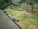 Aerial view showcasing the expansive backyard with a fire pit, deck, and lush greenery at 7656 Eastbourne Rd, Charlotte, NC 28227