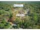 An aerial view of the property showing its location with tree coverage and proximity to Downtown Matthews at 7656 Eastbourne Rd, Charlotte, NC 28227