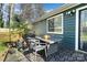 Backyard with a patio set, grill, and newly stained wooden deck at 7656 Eastbourne Rd, Charlotte, NC 28227