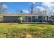 Spacious backyard with a deck, lush green grass, and mature trees, perfect for outdoor entertaining at 7656 Eastbourne Rd, Charlotte, NC 28227