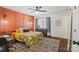 Comfortable bedroom features a ceiling fan, a stylish accent wall, and a patterned rug at 7656 Eastbourne Rd, Charlotte, NC 28227