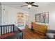 Bedroom shows a crib, dresser, wall art, and hardwood floors throughout at 7656 Eastbourne Rd, Charlotte, NC 28227
