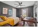 Bedroom with dark walls, light carpet, ceiling fan, and natural light throughout at 7656 Eastbourne Rd, Charlotte, NC 28227