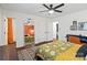 Cozy bedroom showing mirrored closet doors, access to bathroom, and ceiling fan at 7656 Eastbourne Rd, Charlotte, NC 28227