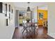Elegant dining area with a wooden table, modern light fixture, and sliding glass doors to the backyard at 7656 Eastbourne Rd, Charlotte, NC 28227