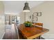 Warm dining room features a wooden table, charming décor, and a view into the living area at 7656 Eastbourne Rd, Charlotte, NC 28227