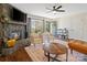 Cozy living room with a stone fireplace, comfortable seating, and plenty of natural light at 7656 Eastbourne Rd, Charlotte, NC 28227
