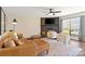 Comfortable living room showcases a leather sofa, stone fireplace, ceiling fan and two armchairs at 7656 Eastbourne Rd, Charlotte, NC 28227