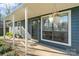 Inviting covered porch with hanging flower baskets, offering a cozy entrance to the home at 7656 Eastbourne Rd, Charlotte, NC 28227