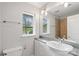 Bright bathroom features a large mirror, white vanity, and window offering natural light at 840 Garden District Dr, Charlotte, NC 28202