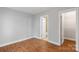 Neutral bedroom with hardwood floors with an interior door to the bathroom at 840 Garden District Dr, Charlotte, NC 28202