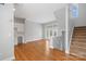 Open-concept living area features hardwood floors, white cabinets, and staircase at 840 Garden District Dr, Charlotte, NC 28202