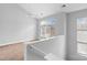 Bright loft with a window with a view, carpet, and a white railing at 840 Garden District Dr, Charlotte, NC 28202