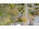 Aerial view showcasing the home's layout, surrounding trees, street access, and proximity to nearby buildings at 8425 E Franklin St, Mount Pleasant, NC 28124