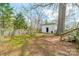 View of the grassy backyard with a small outbuilding and partial fencing at 8425 E Franklin St, Mount Pleasant, NC 28124